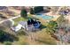 Unique aerial view shows spacious backyard, tennis court, patio, and lush greenery at 5690 Rutland Trce, Lithonia, GA 30058