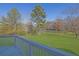 Picturesque backyard view from the deck showcasing a lush green lawn and serene pond at 5690 Rutland Trce, Lithonia, GA 30058