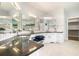 Luxurious bathroom with granite counters, double sinks, vanity lighting, and a walk-in closet at 5690 Rutland Trce, Lithonia, GA 30058