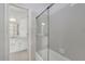 Bright bathroom with a tub-shower combo featuring sleek glass doors at 5690 Rutland Trce, Lithonia, GA 30058