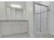 Bathroom with modern fixtures, large mirror, and stylish glass enclosed shower at 5690 Rutland Trce, Lithonia, GA 30058