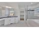 Elegant bathroom featuring double vanity, sleek glass shower, and a luxurious soaking tub at 5690 Rutland Trce, Lithonia, GA 30058