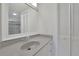 Bright bathroom featuring a large mirror over the sink with a shower/tub combo at 5690 Rutland Trce, Lithonia, GA 30058