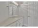 Clean bathroom featuring a white vanity, large mirror and modern lighting fixture at 5690 Rutland Trce, Lithonia, GA 30058