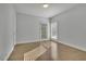 Bedroom with hardwood floors and two large windows allowing ample sunlight at 5690 Rutland Trce, Lithonia, GA 30058