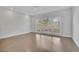 Bright bedroom with a large window offering natural light and scenic outdoor views and hardwood floors at 5690 Rutland Trce, Lithonia, GA 30058