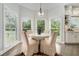 Charming breakfast nook with a round table, four chairs, and large windows with a view at 5690 Rutland Trce, Lithonia, GA 30058