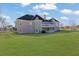 Expansive backyard of home featuring a covered patio and a well-maintained lawn at 5690 Rutland Trce, Lithonia, GA 30058