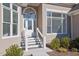 Close up of home entrance with elegant stairs, hanging light fixture, and lush landscaping at 5690 Rutland Trce, Lithonia, GA 30058