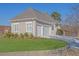 Side view of a home with a two-car garage, neutral siding, and professionally landscaped front lawn at 5690 Rutland Trce, Lithonia, GA 30058