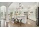 Bright, modern kitchen with white cabinets, an island with seating, stainless steel appliances, and plenty of counter space at 5690 Rutland Trce, Lithonia, GA 30058