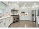 Gourmet kitchen with quartz countertops, a professional-grade stove, stainless steel appliances, and custom cabinetry at 5690 Rutland Trce, Lithonia, GA 30058