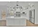 Modern kitchen with a large center island, stainless steel appliances and white cabinets at 5690 Rutland Trce, Lithonia, GA 30058
