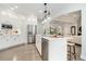 Bright, modern kitchen with stainless appliances, white cabinetry, and a center island with pendant lighting at 5690 Rutland Trce, Lithonia, GA 30058