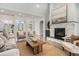 Bright living room featuring hardwood floors, a stone fireplace, a neutral color palette, and ample natural light at 5690 Rutland Trce, Lithonia, GA 30058