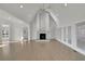 Expansive living room with a modern fireplace, high ceilings, and abundant natural light at 5690 Rutland Trce, Lithonia, GA 30058