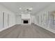 Spacious living room with stone fireplace, ceiling fan, and lots of natural light at 5690 Rutland Trce, Lithonia, GA 30058