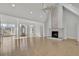 Open concept living room with fireplace, high ceilings and hardwood flooring at 5690 Rutland Trce, Lithonia, GA 30058
