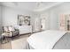 Spacious main bedroom featuring a sitting area, stylish dresser, and access to the ensuite bathroom at 5690 Rutland Trce, Lithonia, GA 30058