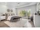 Serene main bedroom with tray ceilings, large windows, and neutral decor for a relaxing ambiance at 5690 Rutland Trce, Lithonia, GA 30058