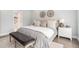 Beautifully staged main bedroom with a cozy bench, plush bedding, and elegant decor at 5690 Rutland Trce, Lithonia, GA 30058