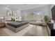 Serene main bedroom with a large window, neutral tones, and a cozy sitting area at 5690 Rutland Trce, Lithonia, GA 30058