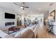 Open concept living room featuring a modern fireplace, TV, and seamless flow into the kitchen and dining area at 5833 Schelton Se Pl, Mableton, GA 30126