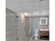 This bathroom has a glass shower, gray tiling, a lighted mirror and stylish vanity sink at 620 Peachtree Ne St # 1613, Atlanta, GA 30308