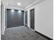 Hallway with carpet flooring, leading to several doors at 620 Peachtree Ne St # 1613, Atlanta, GA 30308