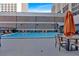 Outdoor swimming pool offers a refreshing escape, complete with lounge chairs, tables, and umbrellas for relaxation at 620 Peachtree Ne St # 1613, Atlanta, GA 30308