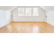 Spacious attic bedroom with hardwood floors, ample natural light, and minimalist design create a serene retreat at 629 Hansell Se St, Atlanta, GA 30312