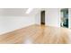 Spacious attic room with hardwood floors, skylight, doorway, and minimalist design for a flexible living space at 629 Hansell Se St, Atlanta, GA 30312