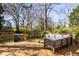 A wooden deck with wood furnishings overlooks a grass yard and mature trees at 629 Hansell Se St, Atlanta, GA 30312