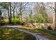 Green backyard featuring a stone walkway leading to a wooden fence and lush landscaping at 629 Hansell Se St, Atlanta, GA 30312