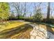 View of the well-manicured backyard featuring a stone pathway leading towards the home at 629 Hansell Se St, Atlanta, GA 30312