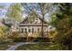 Backyard with lush landscaping, a wooden deck, and stone pathway leading to the house at 629 Hansell Se St, Atlanta, GA 30312