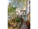 View of the backyard of the property with a stone pathway, small plants, and green door at 629 Hansell Se St, Atlanta, GA 30312