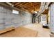 Spacious unfinished basement with concrete block walls and exposed ceiling with utilities at 629 Hansell Se St, Atlanta, GA 30312