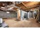 Spacious unfinished basement with concrete walls, exposed wood ceiling, shelving, and stairs at 629 Hansell Se St, Atlanta, GA 30312