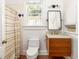 Compact bathroom with a wooden vanity, neutral walls and a shower with a striped curtain at 629 Hansell Se St, Atlanta, GA 30312