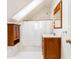 Cozy bathroom under the eaves features a shower, vanity with wood cabinets, and a skylight for natural light at 629 Hansell Se St, Atlanta, GA 30312