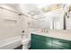 Bathroom featuring tile floors, a shower-tub, green cabinets and a large mirror at 629 Hansell Se St, Atlanta, GA 30312