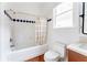 Cozy bathroom featuring a bathtub with blue detailing and tiled floors at 629 Hansell Se St, Atlanta, GA 30312