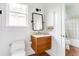 A clean, efficient bathroom design featuring a modern floating wood vanity and stylish rectangular mirror at 629 Hansell Se St, Atlanta, GA 30312