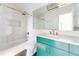 Stylish bathroom featuring teal vanity cabinet, shower-tub combination, and modern fixtures under a large mirror at 629 Hansell Se St, Atlanta, GA 30312