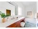 Bright bathroom with modern fixtures, vanity with stool, a tub, and colorful tile flooring at 629 Hansell Se St, Atlanta, GA 30312