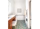 Bright bathroom with a soaking tub, a vanity with a wooden cabinet, and blue and green tile flooring at 629 Hansell Se St, Atlanta, GA 30312