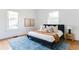 Bright bedroom with large windows, modern decor, and a stylish blue patterned rug at 629 Hansell Se St, Atlanta, GA 30312