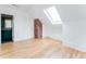 Bright bedroom showcasing hardwood floors, skylight, and an ensuite bathroom with a stylish teal vanity at 629 Hansell Se St, Atlanta, GA 30312