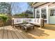 A cozy outdoor seating area with a cushioned sofa and wooden coffee table on the deck at 629 Hansell Se St, Atlanta, GA 30312